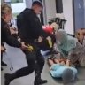 Video of police kicking man on ground at British airport sparks protests