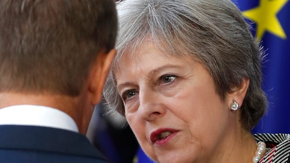 British Prime Minister Theresa May speaks with European Council President Donald Tusk at an EU-ASEM summit in Brussels on  Friday.