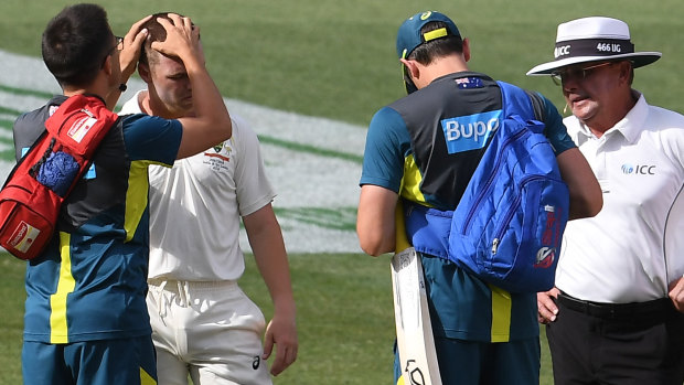 New concussion rules: A trainer examines Travis Head after he sustained a head knock in the Boxing Day Test against India in 2018. 