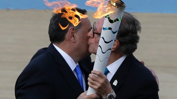 Rio 2016 organising committee president Carlos Nuzman, right, receives the Olympic Flame from the head of Greece’s Olympic Committee, Spyros Capralos at Panathinean stadium in Athens, in 2016. 