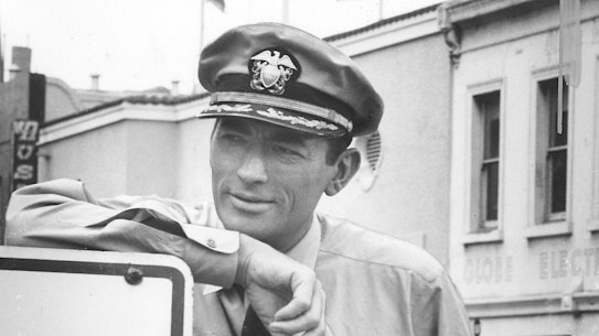 Actor Gregory Peck relaxes  during the shoot in Lonsdale Street, Melbourne.