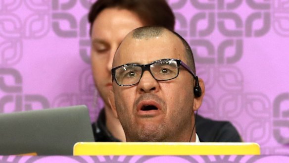 Tough viewing: Michael Cheika watches England eliminate Australia from the World Cup.