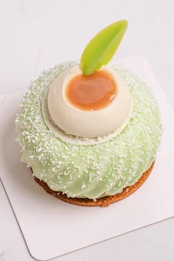 Onde petit gateau with layers of brown sugar shortcrust, pandan chiffon cake, palm sugar and coconut pannacotta, and pandan diplomat mousse, anda silky caramel sauce.