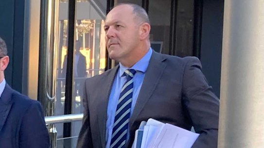 Senior Sergeant Scott Stahlhut (right) leaves Toowoomba Magistrates Court on Wednesday afternoon.