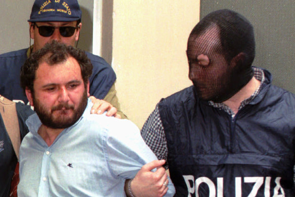 Giovanni Brusca, under arrest, pictured outside police headquarters in Palermo in 1996. 