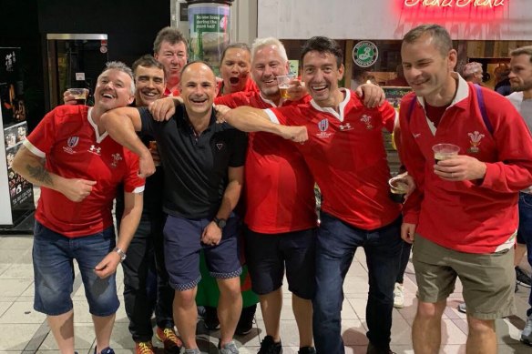 Referee Jaco Peyper (black shirt) has found himself in hot water after posing for this photo with Wales fans. 