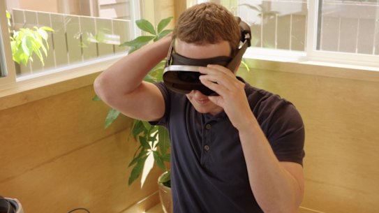 Mark Zuckerberg tries a prototype Meta headset, which uses holographic lenses to shrink complex optics into a small package. Meta said creating a consumer version would require lasers that don’t exist yet.