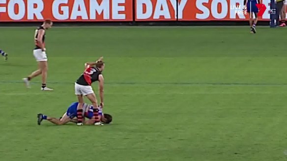 Essendon’s Darcy Parish signals for assistance after Tom Liberatore collapsed.