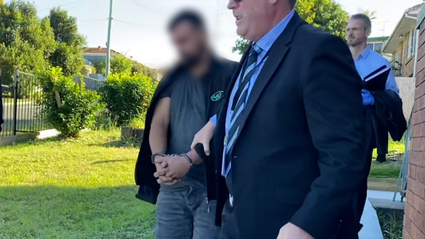 Queensland police arrest a man in Brisbane on Wednesday.