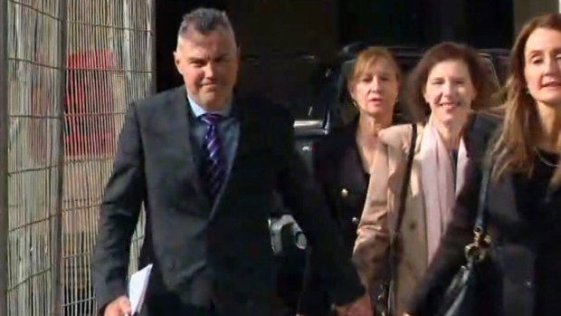 Stephen Kaless with his wife and legal team outside court on Monday.