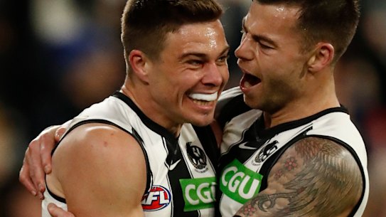 Josh Thomas celebrates a telling goal with Collingwood teammate Jamie Elliott.
