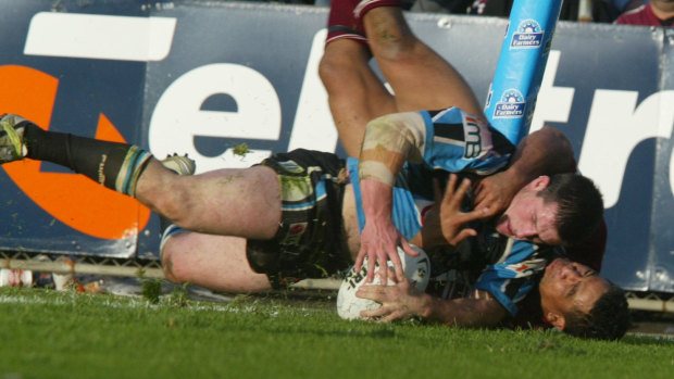 Old sparring partners: Hopoate tries to stop Gallen from scoring for the Sharks in a match against Manly in 2004.