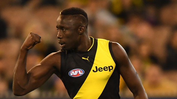 Mabior Chol of the Tigers reacts after kicking a goal.