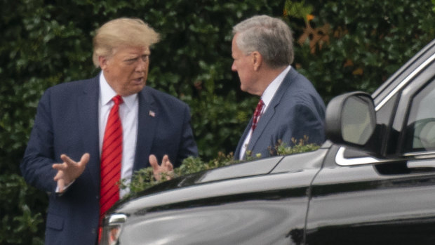 Then US president Donald Trump and his White House chief of staff Mark Meadows, right, talk outside the Oval Office last year.