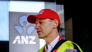 Shayne Elliott sells copies of the Big Issue outside the ANZ's Melbourne office.