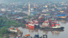 Tugboats and barges transporting coal are moored on the Mahakam River in Samarinda, East Kalimantan, Indonesia.