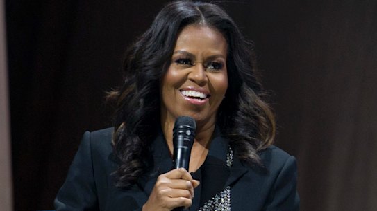 Michelle Obama speaks to the crowd as she presents her anticipated memoir "Becoming" during her book tour stop in Washington, Saturday, Nov. 17, 2018. (AP Photo/Jose Luis Magana)