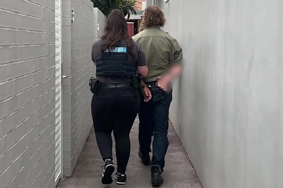 Cameron Spring being led out of his Canterbury home after being arrested last week.