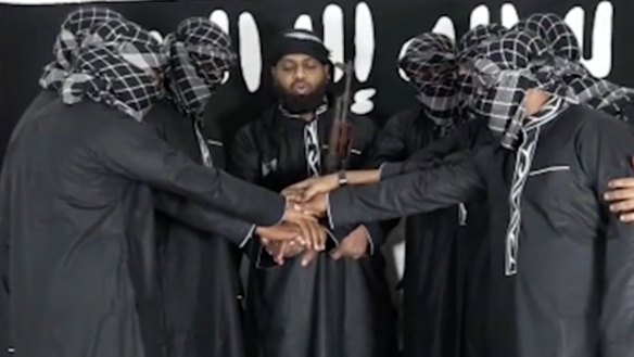 Image posted by Islamic State purports to show attackers in Sri Lanka standing before the terror group's flag. 