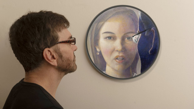 Artist Darren Pryce with his portrait of Brittany Higgins.