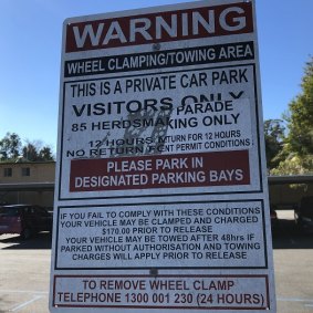 The sign did not warn that a permit was needed to park in a visitor bay. 