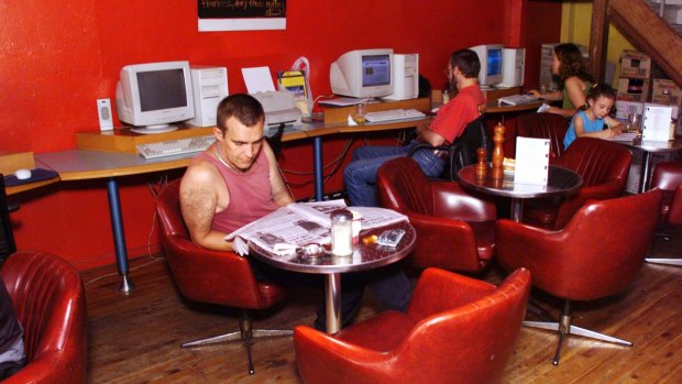 A customer in January 2000 reads the newspaper.
