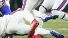 Buffalo Bills safety Damar Hamlin (3) lies on the turf after making a tackle on Cincinnati Bengals wide receiver Tee Higgins, who is blocked from view.