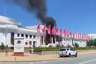 Smoke waves from the front of the old parliament building Thursday morning.