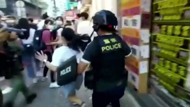 Hong Kong riot police tackled a 12-year-old shopper to the ground as part of a crackdown on protests on Sunday, which should have been election day.