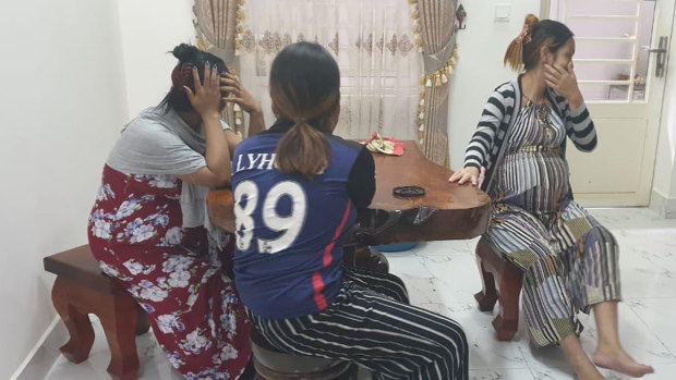 A group of woman in police custody in Cambodia after being arrested for alleged surrogacy.