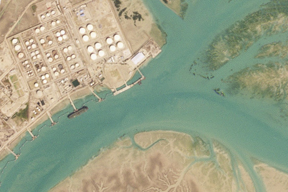 An oil tanker docked at Bandar Mashahr, Iran in February appears to be taking on Iranian crude oil in violation of American sanctions.