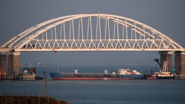 A large cargo ship under the bridge over the Kerch Strait blocked access to the Azov Sea on Sunday.