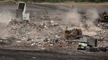Queensland waste trucks dump unprocessed construction waste from NSW at Cleanaway's New Chum landfill in Ipswich after it has passed through Cleanaway's recycling facility at Willawong in January.
