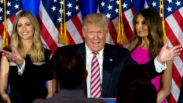 Not cut from the same cloth: Donald Trump with daughter Ivanka and wife Melania. 