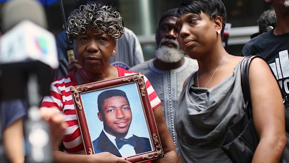 Gwen Carr, mother of Eric Garner, holds a photo of her son in 2015.