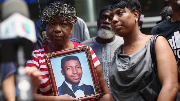 Gwen Carr, mother of Eric Garner, holds a photo of her son in 2015.