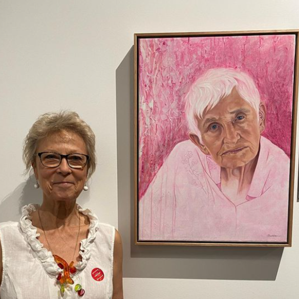 Artist and art teacher Kathy Sullivan with <i>Tradewind Annie</i>, her portrait of Anne Collins selected as a finalist for this year’s Brisbane Portrait Prize. 