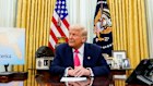 Donald Trump prepares to sign an executive order in the Oval Office of the White House.