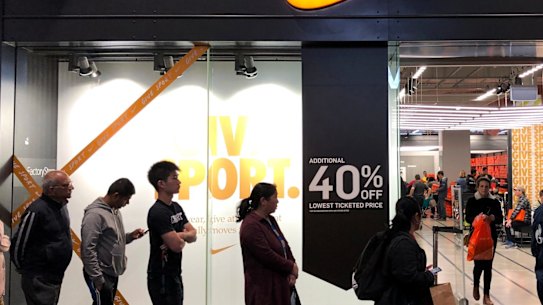 Shoppers queue outside a Nike store in Melbourne for the Black Friday sales. The sales help lift retail sales in November but doubts remain about whether this will be carried through to December results.