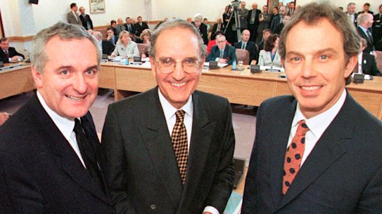 Then Irish prime minister Bertie Ahern, US senator George Mitchell and British prime minister Tony Blair pose after signing the Good Friday Agreement for peace in Northern Ireland in 1998.
