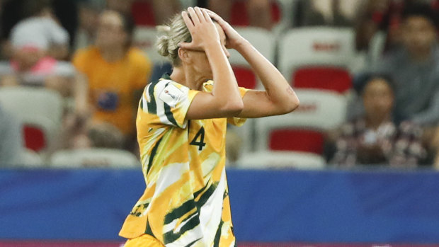 Australia's Alanna Kennedy leaves the pitch after receiving king a red card.