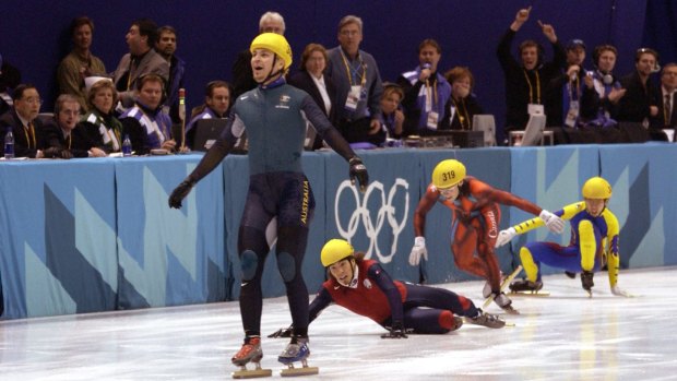 Steven Bradbury crosses the line in first place in the men's 1000m speed skating final during the 2002 Winter Olympics.