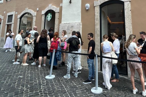 People queue for service at the new Starbucks in Rome.