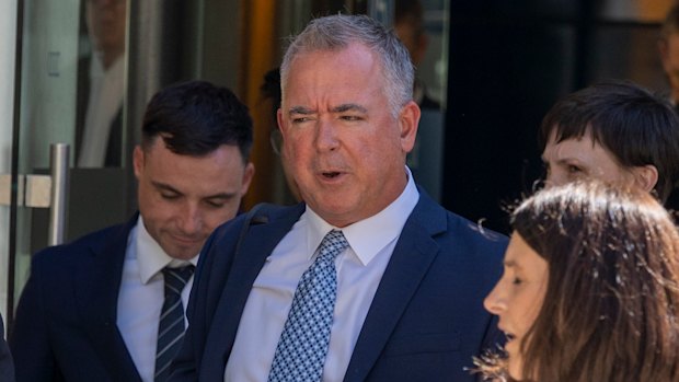 Coles manager of health products Matthew Hankin (light blue tie), outside federal court on Thursday after appearing a witness in the case brought by the ACCC.