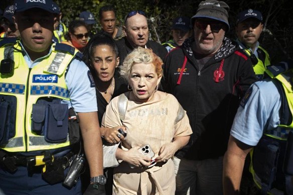 Kellie-Jay Keen-Minshull is escorted from the Auckland event by police.