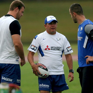Former Bulldogs coach Kevin Moore (centre) talks to his players at training.