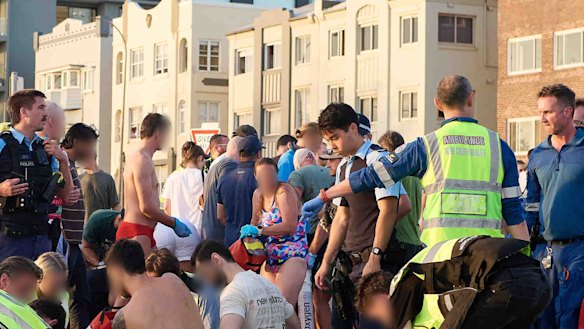 Members of the public help emergency services following the mass shooting at Bondi Beach.