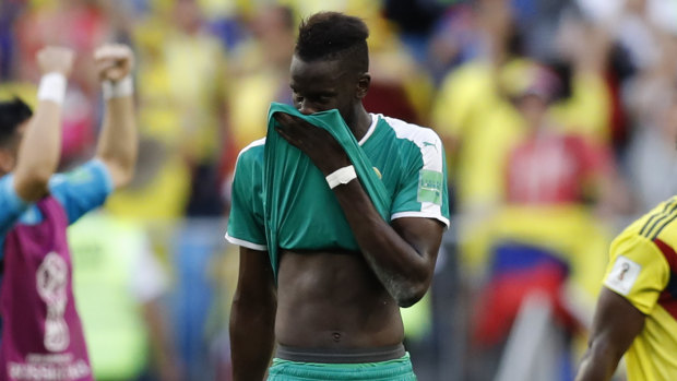 Cruellest of fates: Salif Sane leaves the pitch after Senegal's loss.
