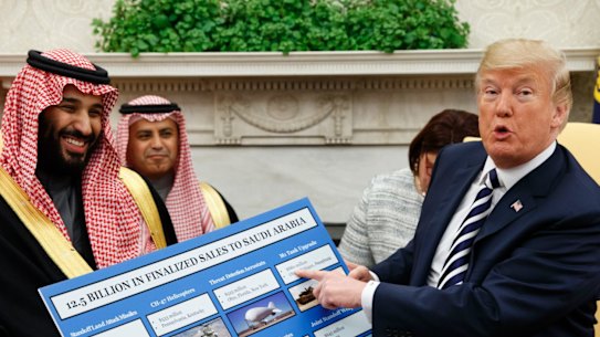 March 2018: President Trump holds a chart highlighting $US12.5 billion in arms sales to Saudi Arabia during a meeting with Saudi Crown Prince Mohammed bin Salman in the Oval Office.