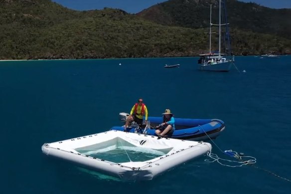 Coral researchers from the Great Barrier Reef Foundation move a coral embryo nursery into position in the Whitsundays.